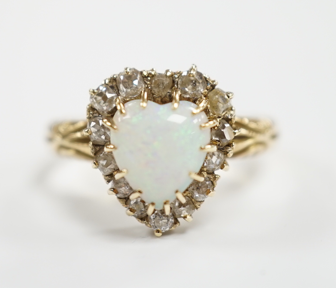 A yellow metal, white opal and diamond set heart shaped cluster ring, size N, gross weight 3.7 grams.